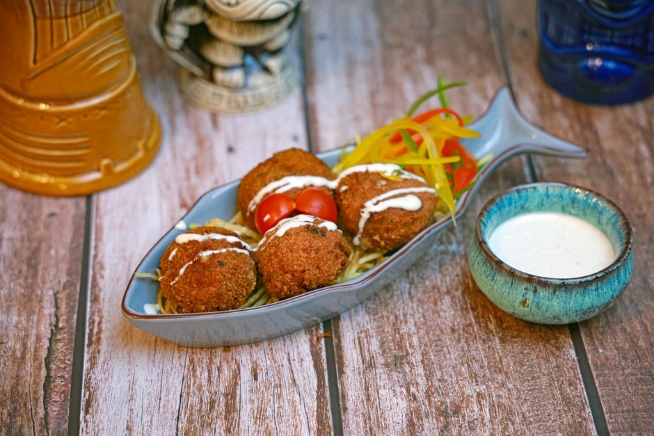 Crispy Corn Fritters with a colorful garnish — food · Party Food