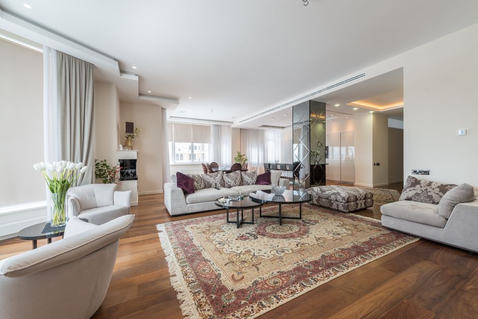 Large Rug in a warm oak palette with layered natural textures — home · Living Rooms